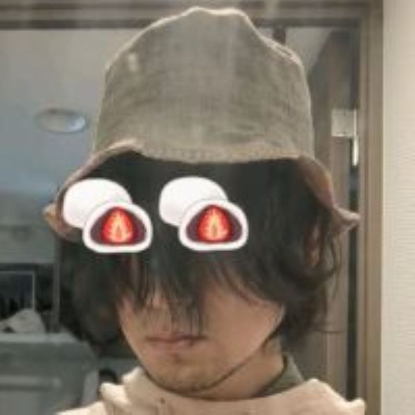 a man wearing a hat, with two emojis over his eyes